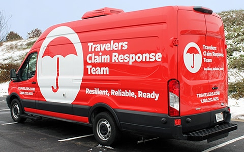 Travelers Claim Response Van in a parking lot.